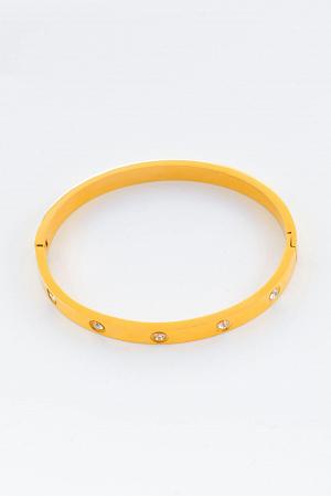 Styv guldarmring med stenar